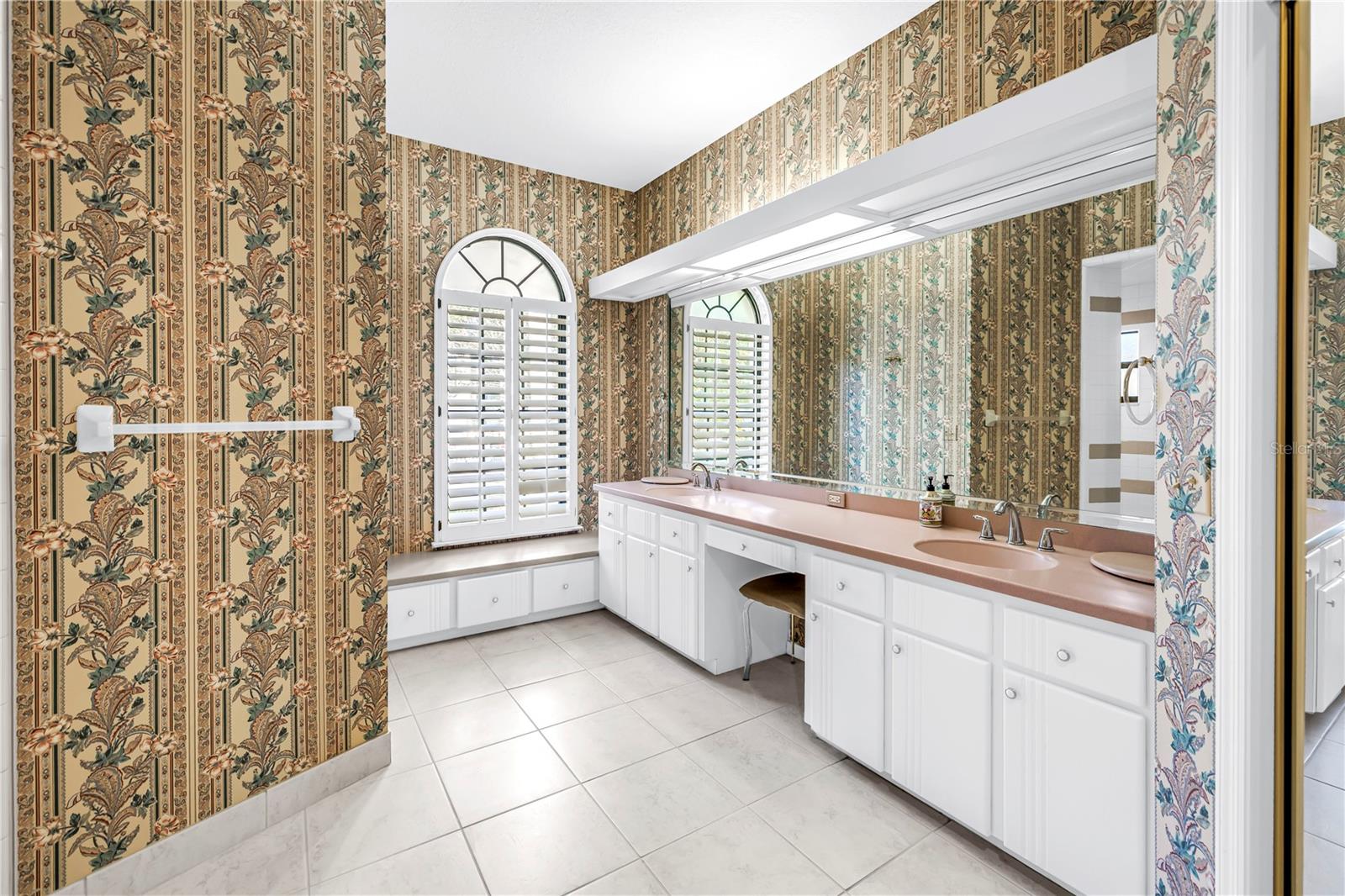 Primary Bath with long dual Vanity and dressing table.  Shower is behind wall with towel bar.  SEE VIRTUAL RENDERING IN PHOTO 63