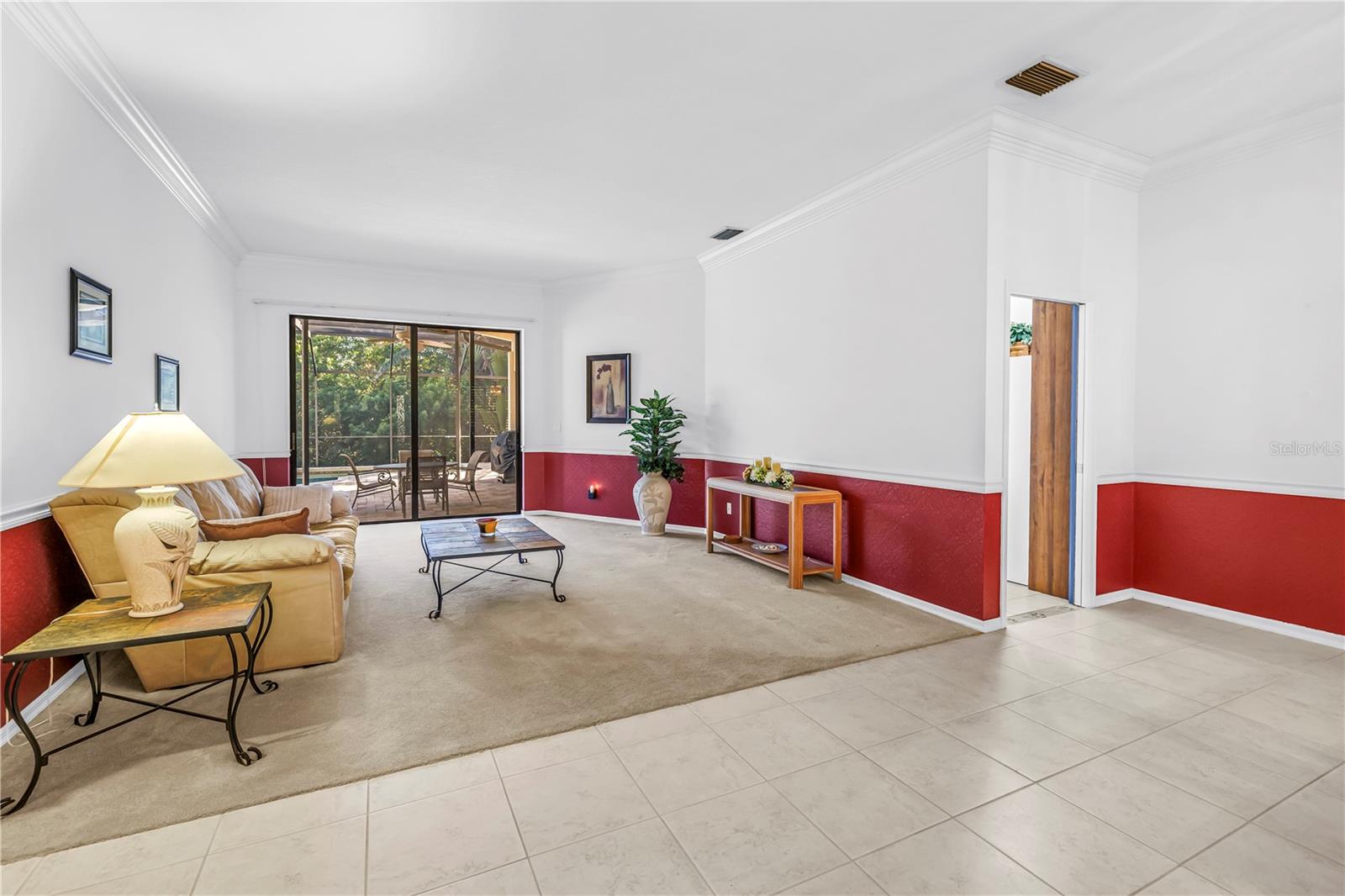 Open concept front room and entry foyer offering an immediate view of the pool oasis through wide 8-ft sliding glass doors set under expansive 10-ft ceilings.  SEE VIRTUAL RENDERING IN PHOTO 54