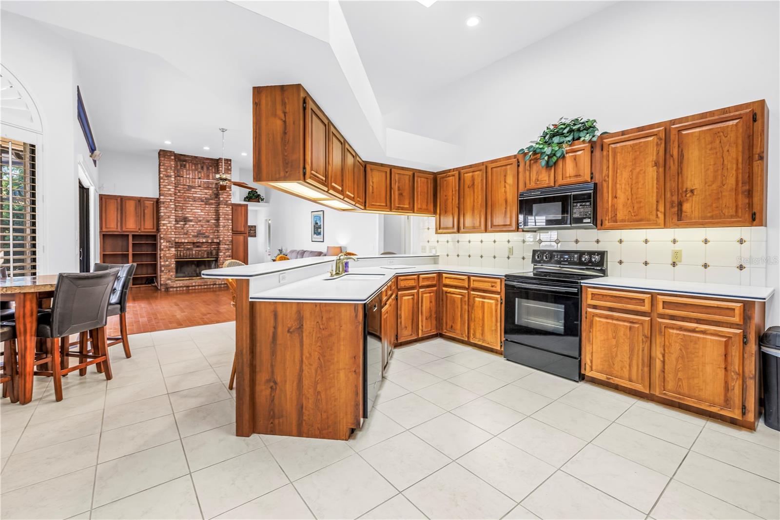 Open Concept Kitchen Great Room with soaring 12-Foot Ceilings and wood burning fireplace.  SEE VIRTUAL RENDERING IN PHOTO 56