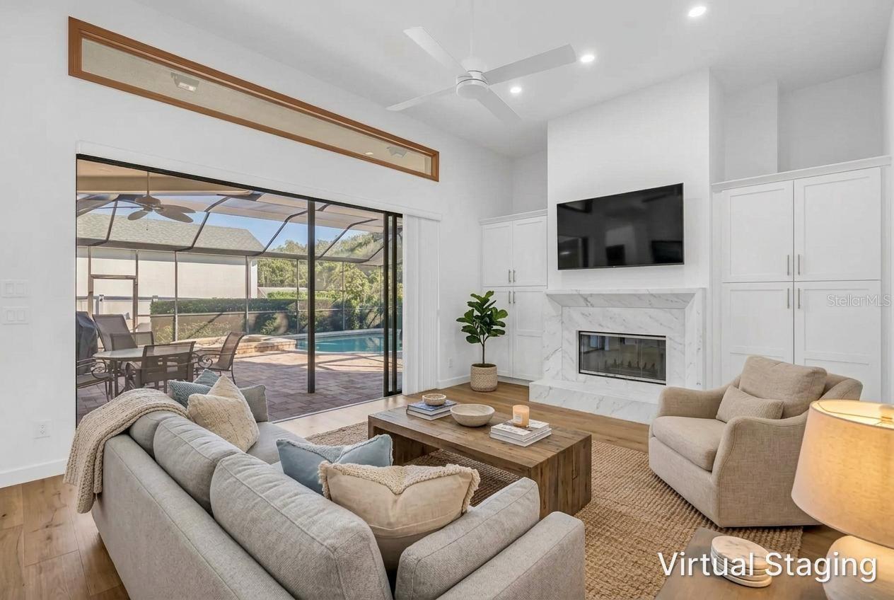 Virtual Updates and staging from previous photo.  New Flooring, Fireplace refacing and hardwood flooring, and staging furniture.