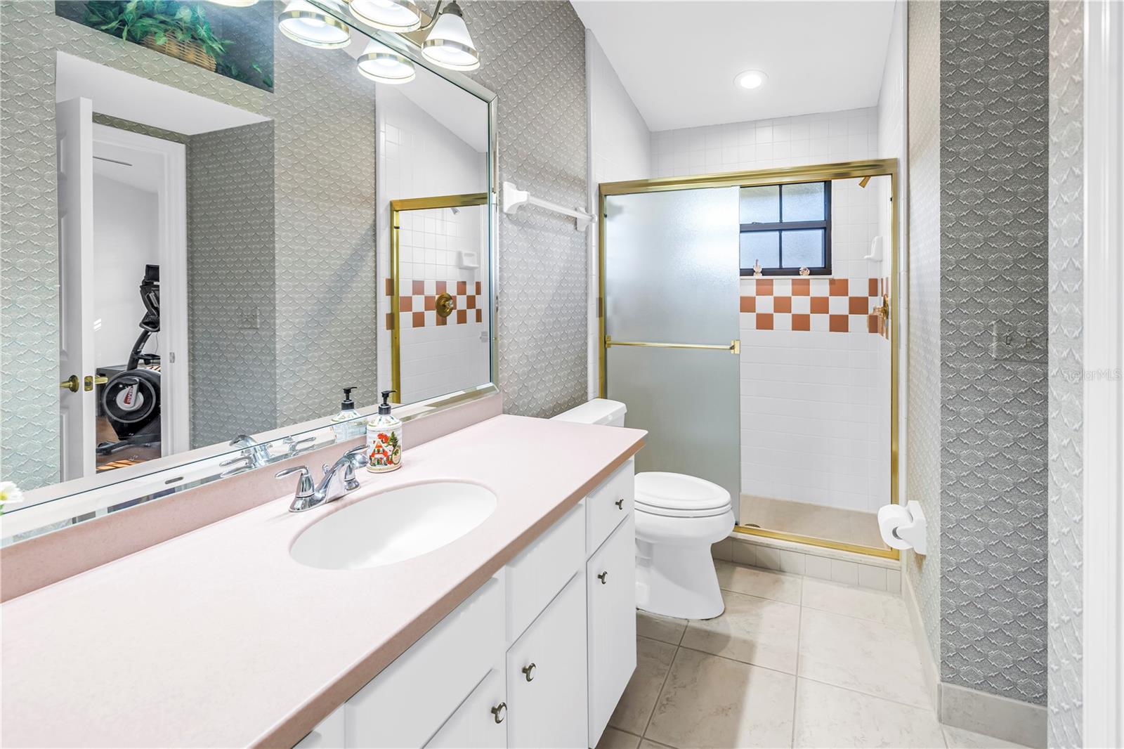 Bath 3 has a walk-in shower and access from the pool and Bedroom 3