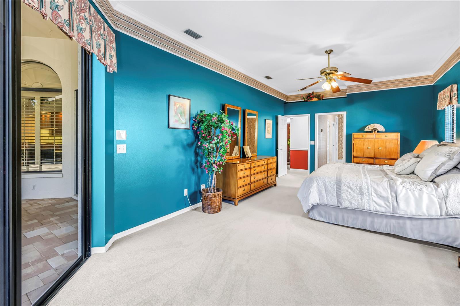 Primary Bedroom with doors to en suite bath and living room.  10 Foot Ceilings, windows and (2) 8-Foot sliders to the pool deck.  SEE VIRTUAL RENDERING IN PHOTO 61