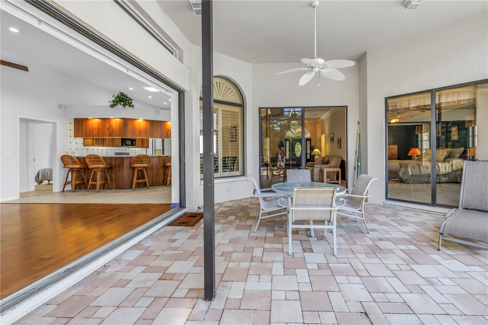 This property features 8-foot, 3-panel sliding glass doors that pocket completely to provide seamless transition from the great room to the outdoor pool lanai, perfect for indoor-outdoor living.