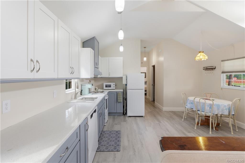 Kitchen Overview  Attractive kitchen offering generous countertop space, plenty of cabinetry, electric range, dishwasher & refrigerator.