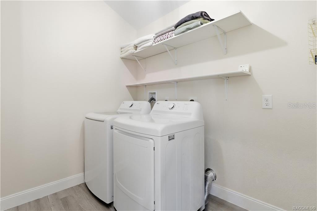 Indoor Laundry Room  Convenient INDOOR LAUNDRY featuring a washer, dryer & overhead shelving for additional storage. Everything has its place!