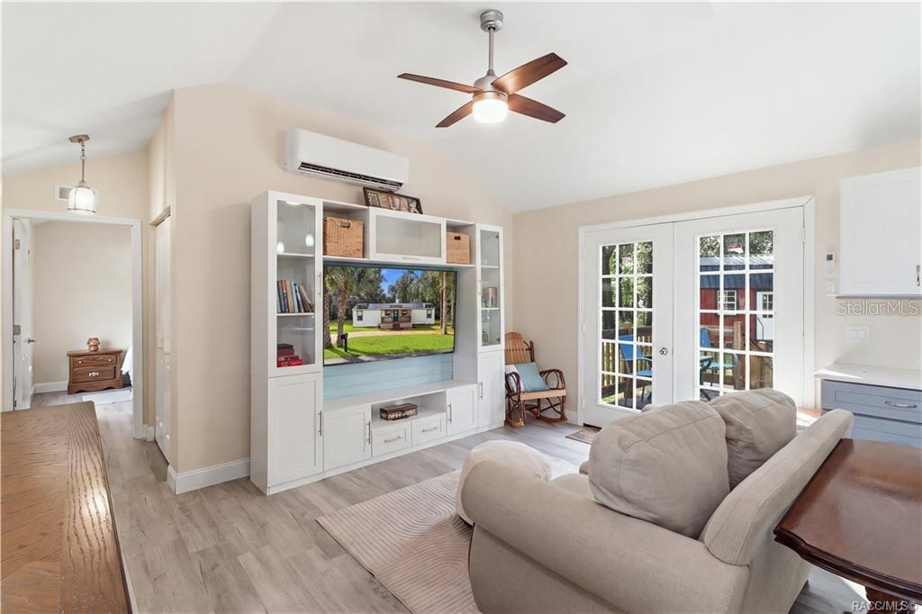 Open Living Area Another beautiful view of the comfortable living room, showcasing the open layout, attractive furnishings, w/ entertainment center & French doors leading outdoors. Open Living Area Another beautiful view of the comfortable living room, showcasing the open layout, attractive furnishings, w/ entertainment center & French doors leading outdoors.