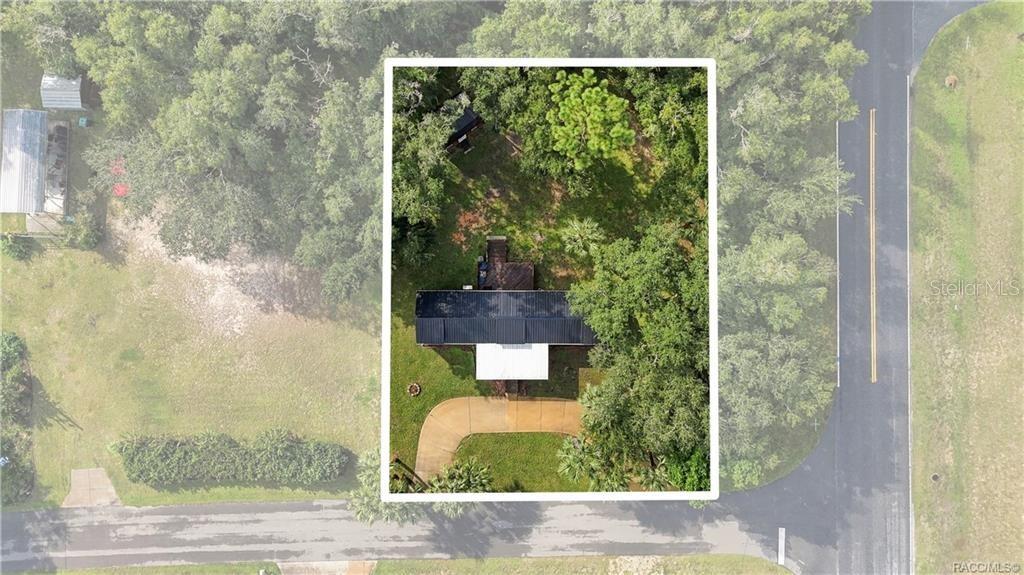 Aerial Property View Overhead perspective showcasing the home on its .29-ACRE CORNER LOT, surrounded by mature trees, greenery & a circular driveway. Aerial Property View Overhead perspective showcasing the home on its .29-ACRE CORNER LOT, surrounded by mature trees, greenery & a circular driveway.