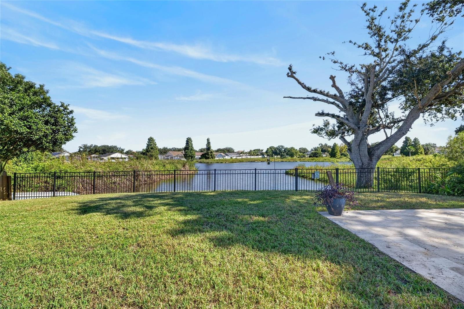 Lake front view with partial uncovered patio