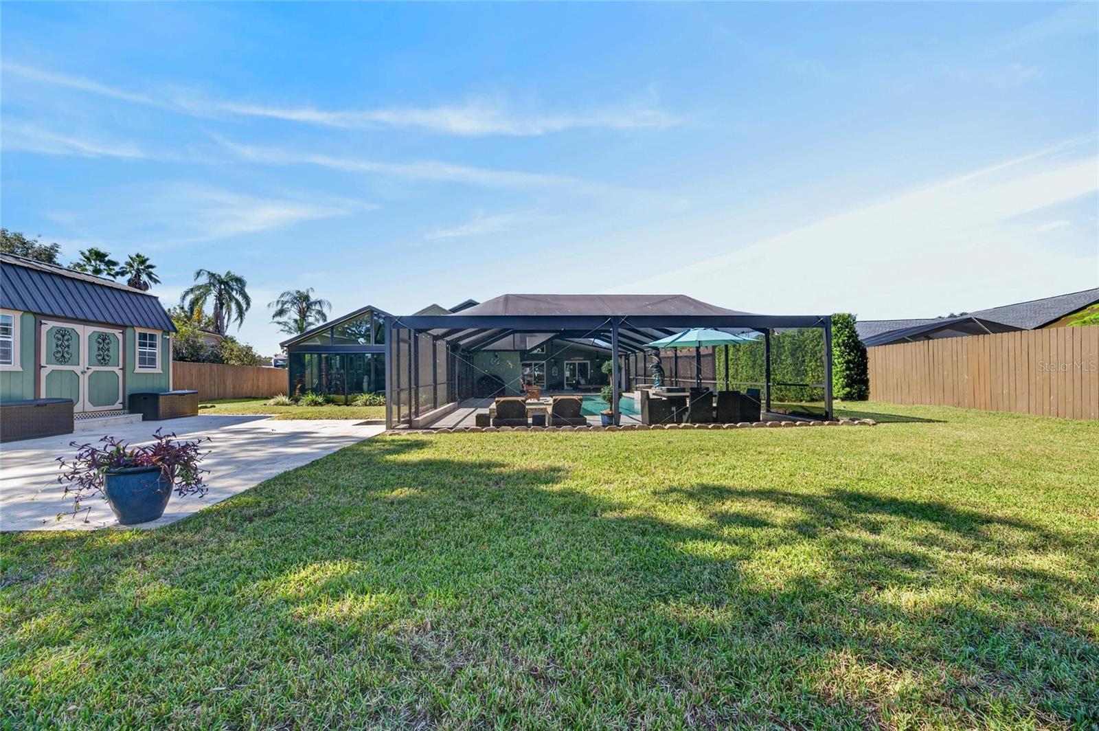 Backyard with uncovered patio as well as large shed