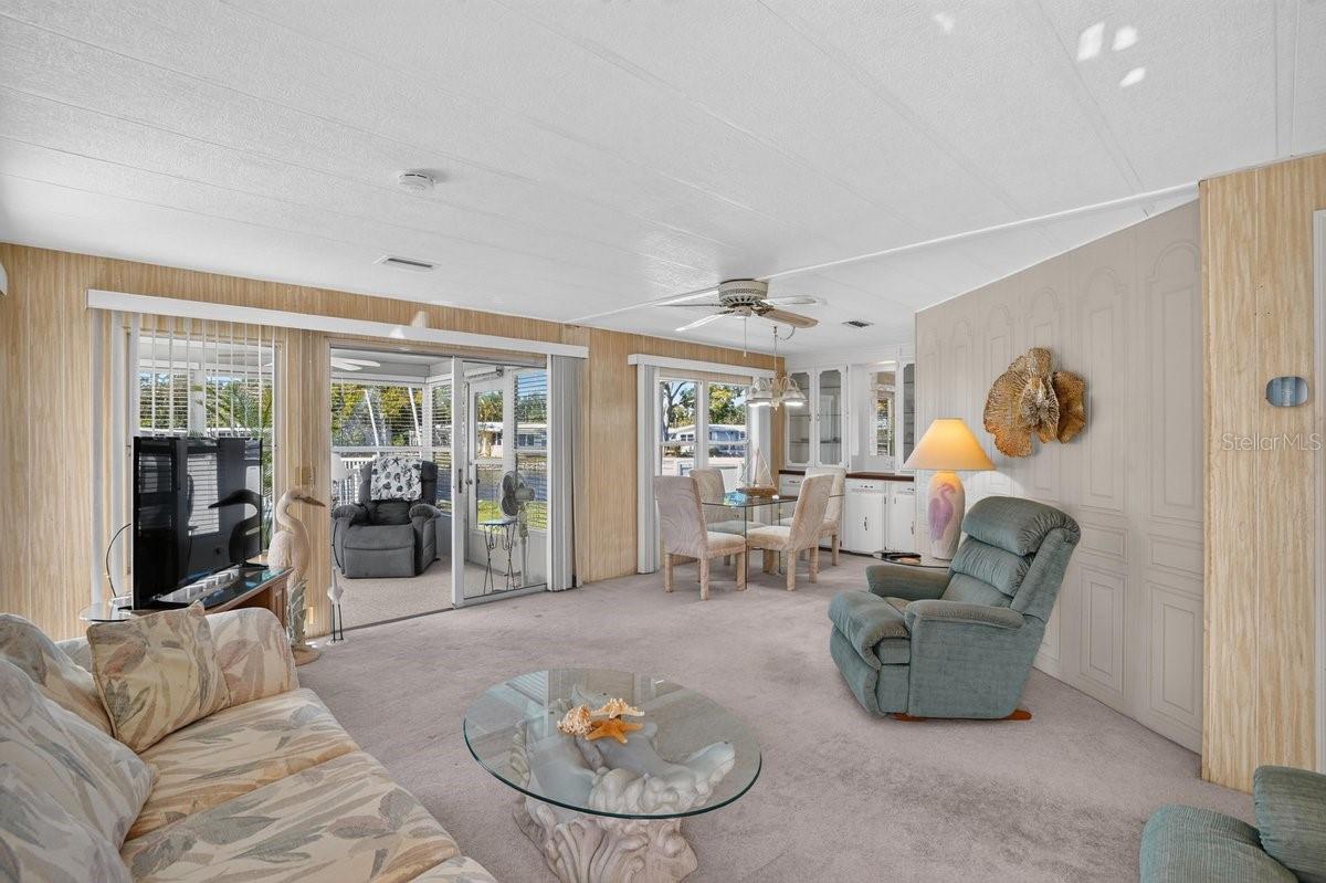 Spacious Living Room Flows to Dining and Enclosed Porch * The Pool is Just Outside Your Door Spacious Living Room Flows to Dining and Enclosed Porch * The Pool is Just Outside Your Door
