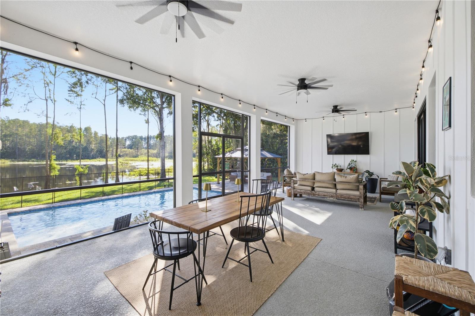 32 FT+ covered, screened, rear porch with TV and fans. 32 FT+ covered, screened, rear porch with TV and fans.