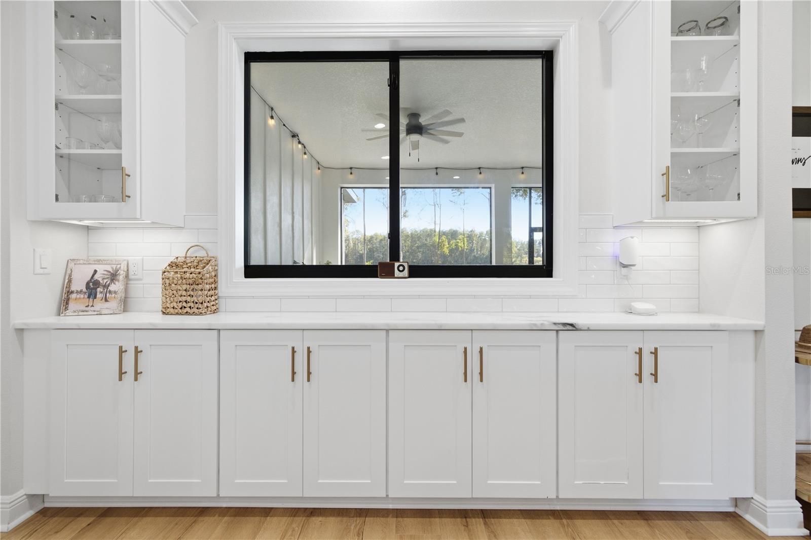 6 FT Pass through window from kitchen to rear porch with 11 FT of custom cabinetry.