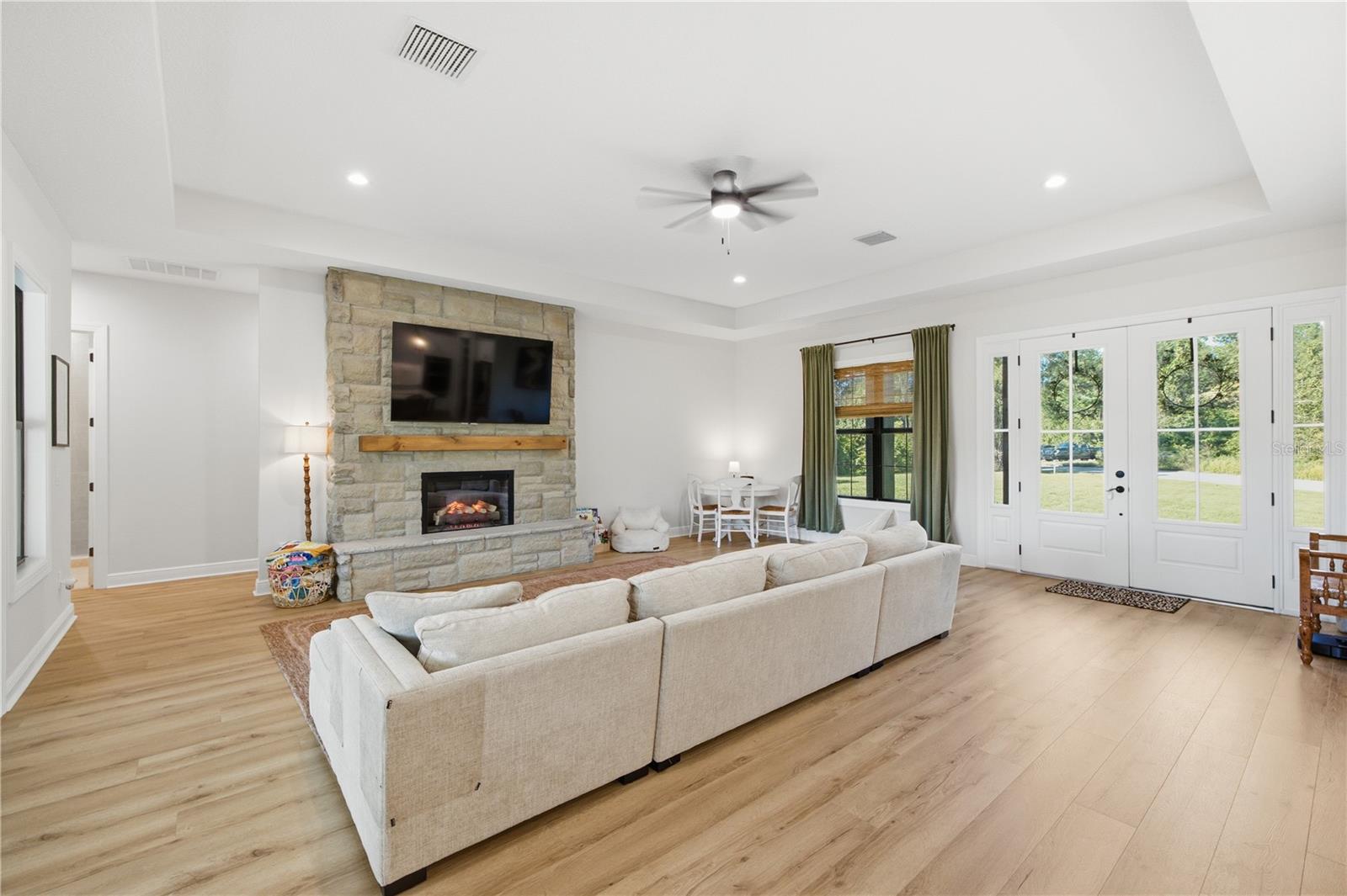 Tons of natural lights and stone detailed electric fireplace.