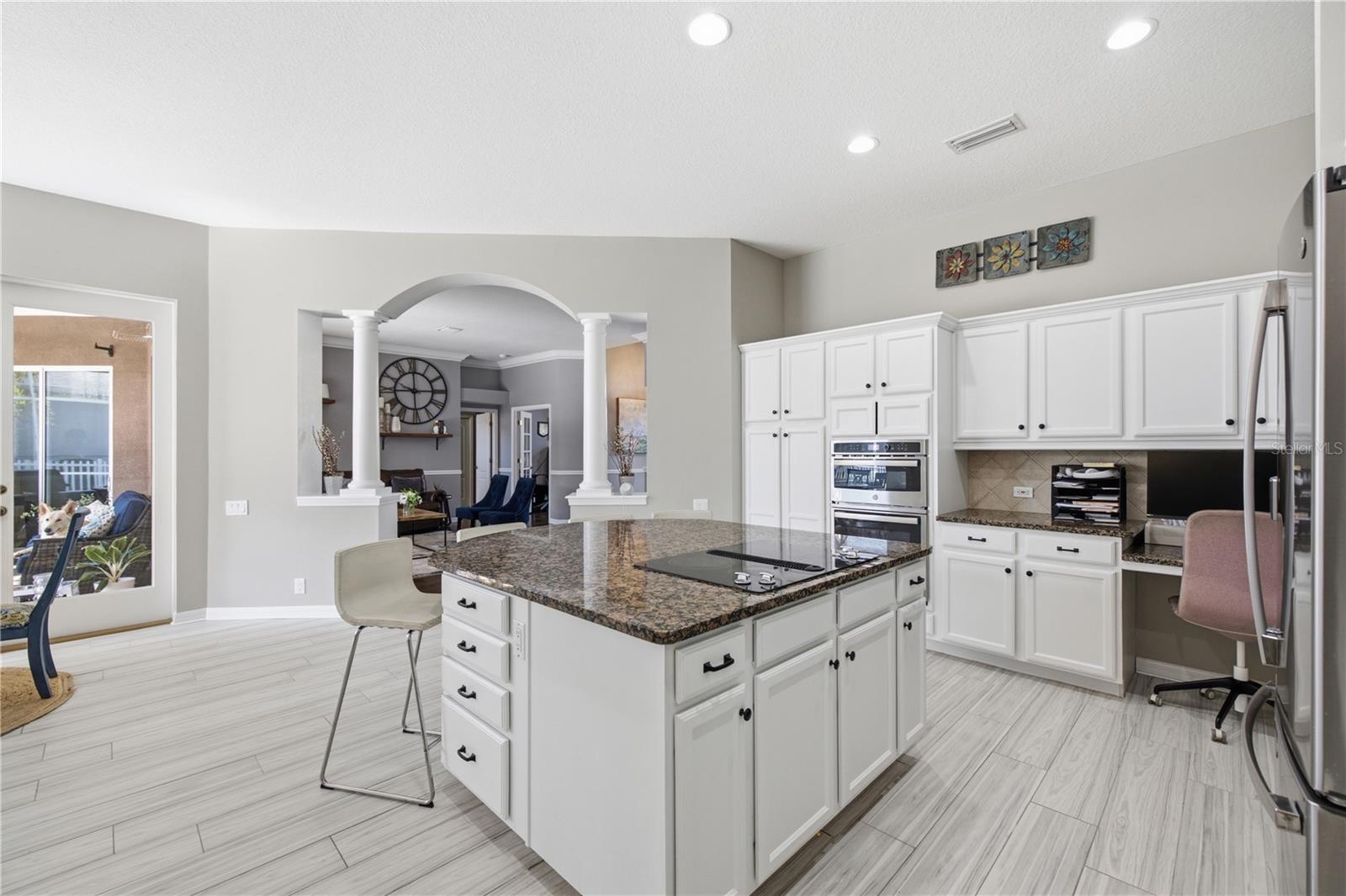 Kitchen Island and Cook top with work station on far side counter area built in.