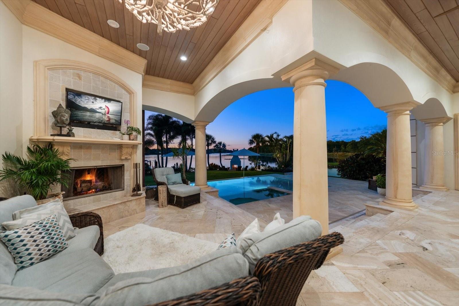 An expansive covered lanai offers inviting seating, a wood-and-gas fireplace and an Alfresco outdoor kitchen An expansive covered lanai offers inviting seating, a wood-and-gas fireplace and an Alfresco outdoor kitchen