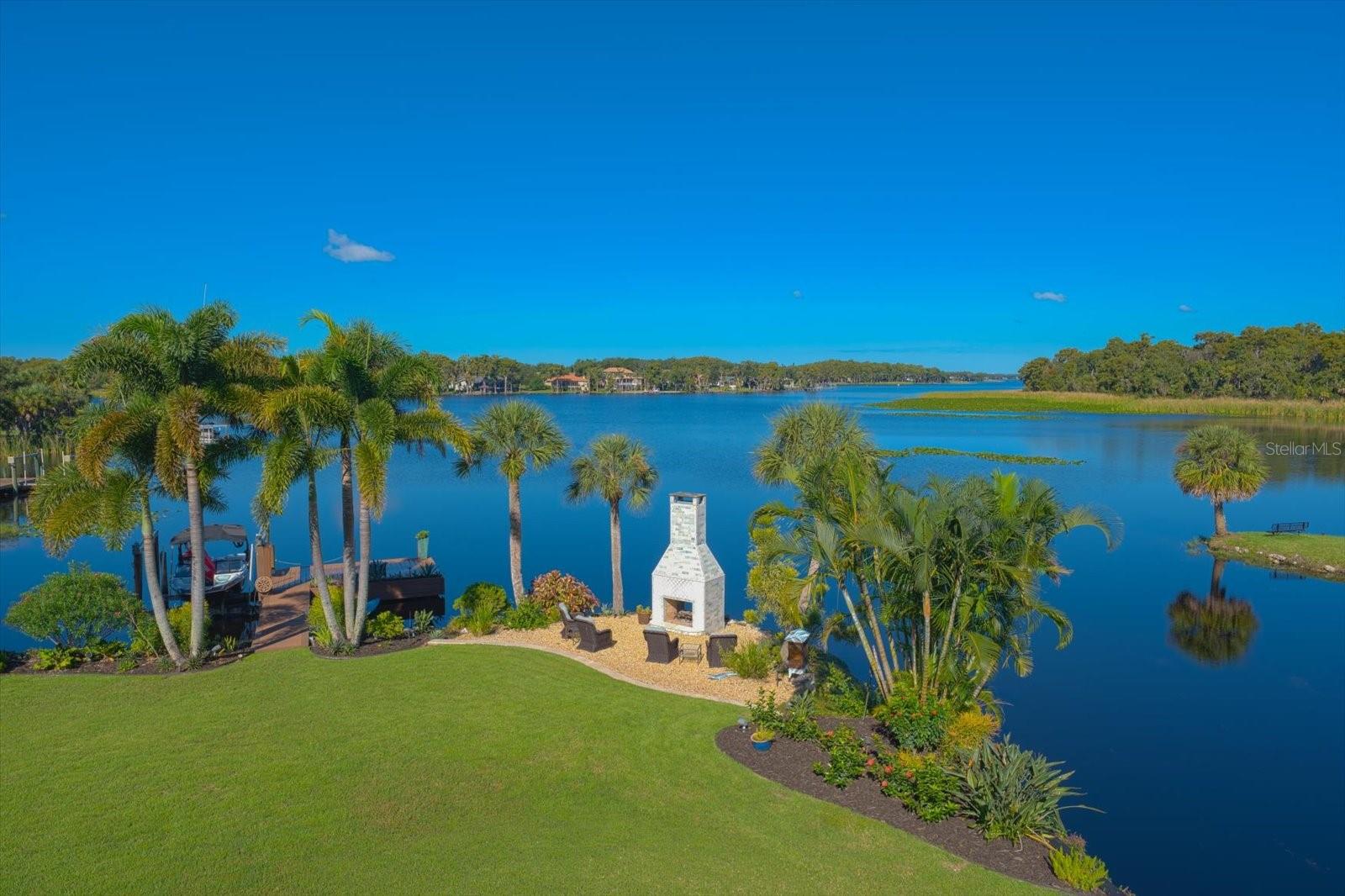 Unbelievable Views! The romantic see-through wood-burning fireplace adds ambiance to the waterfront setting