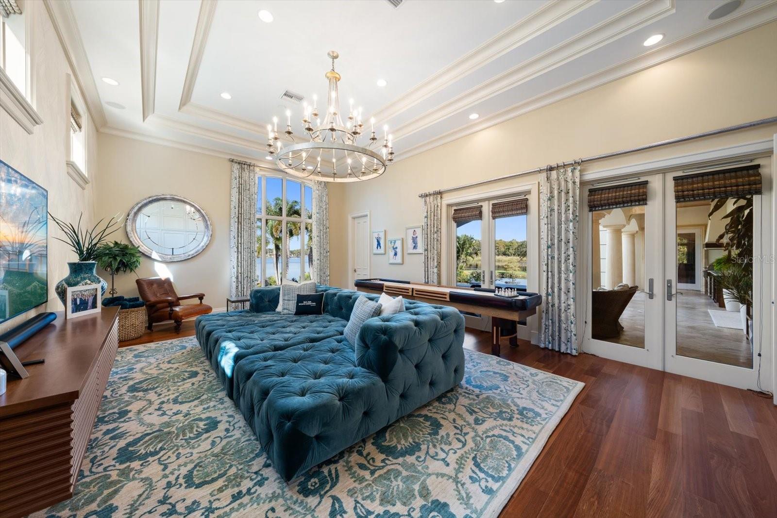 Jaw-Dropping Family Room with Double French Doors leading outside & Built in Murphy Bed