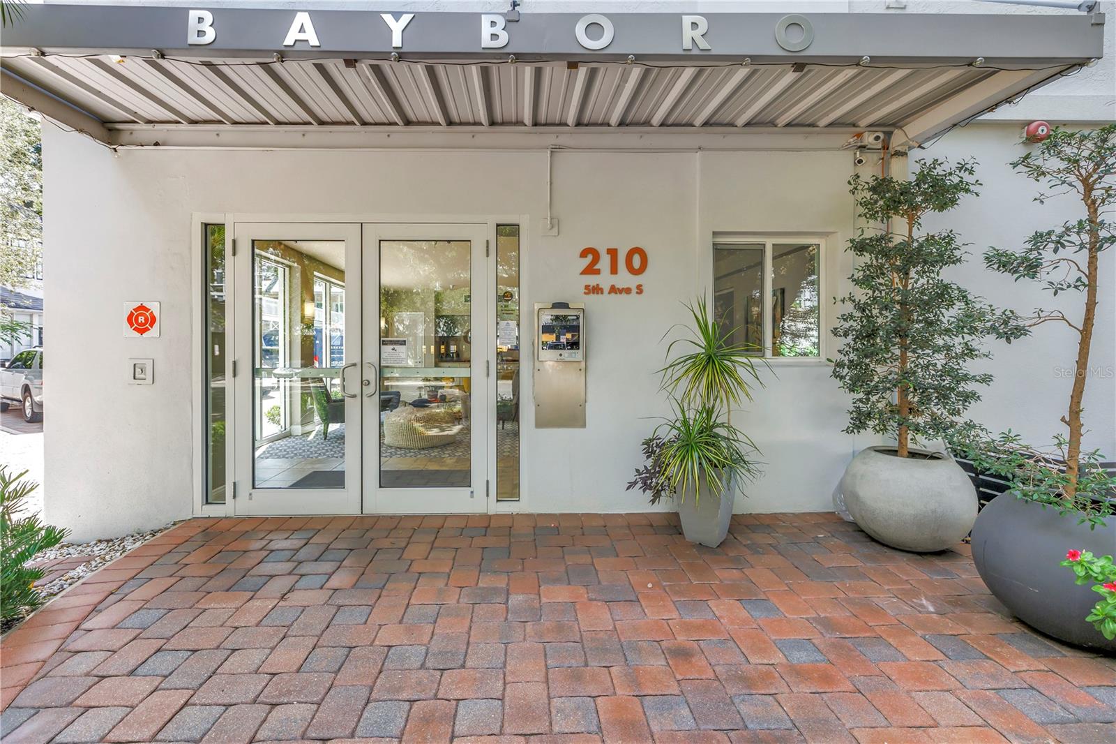Front entry.  High Tech access to the right of the lobby door.  Owners can open the doors remotely using your phone. It's EXTREMELY convenient when receiving deliveries and you are not at home.