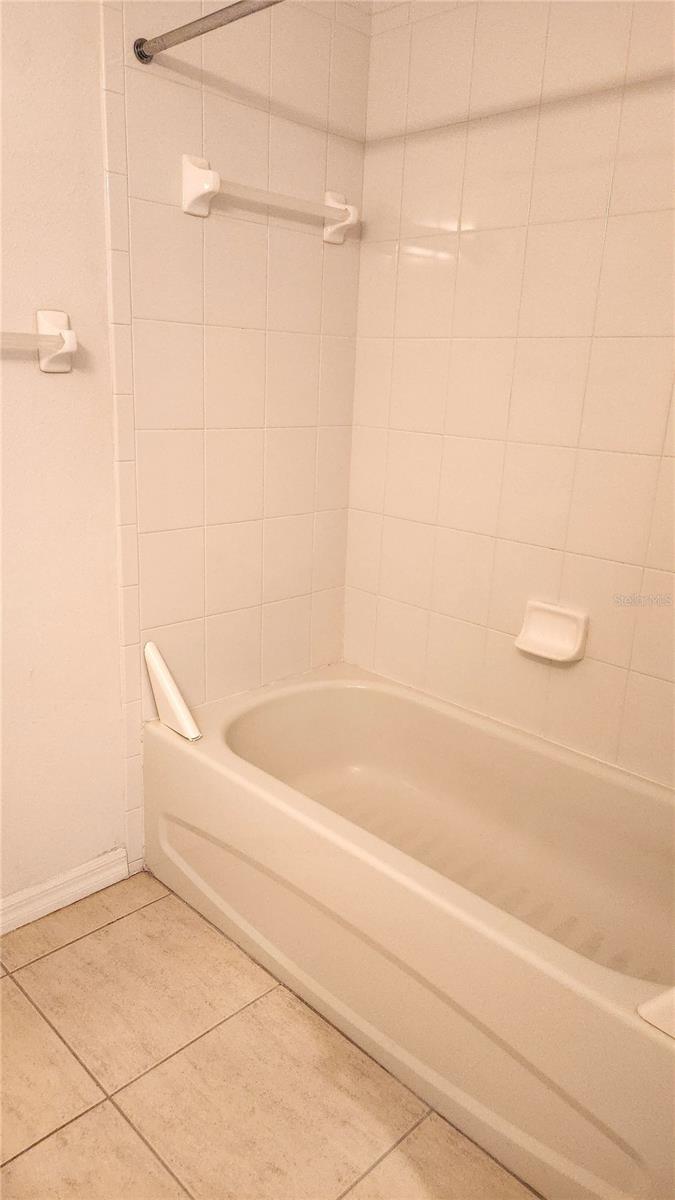 Guest bathroom has a tub/shower combo.