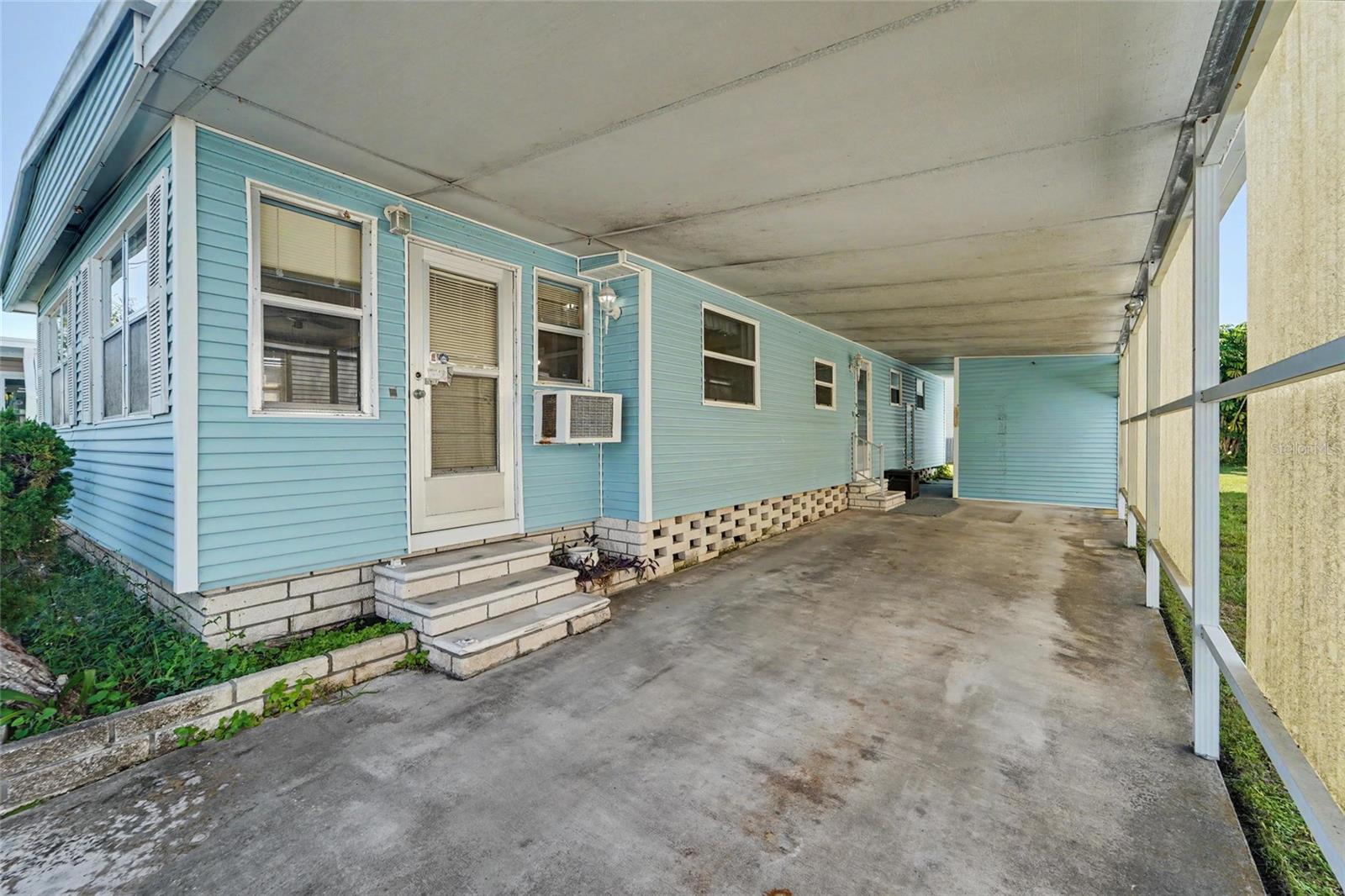 Large Carport and storage shed straight ahead