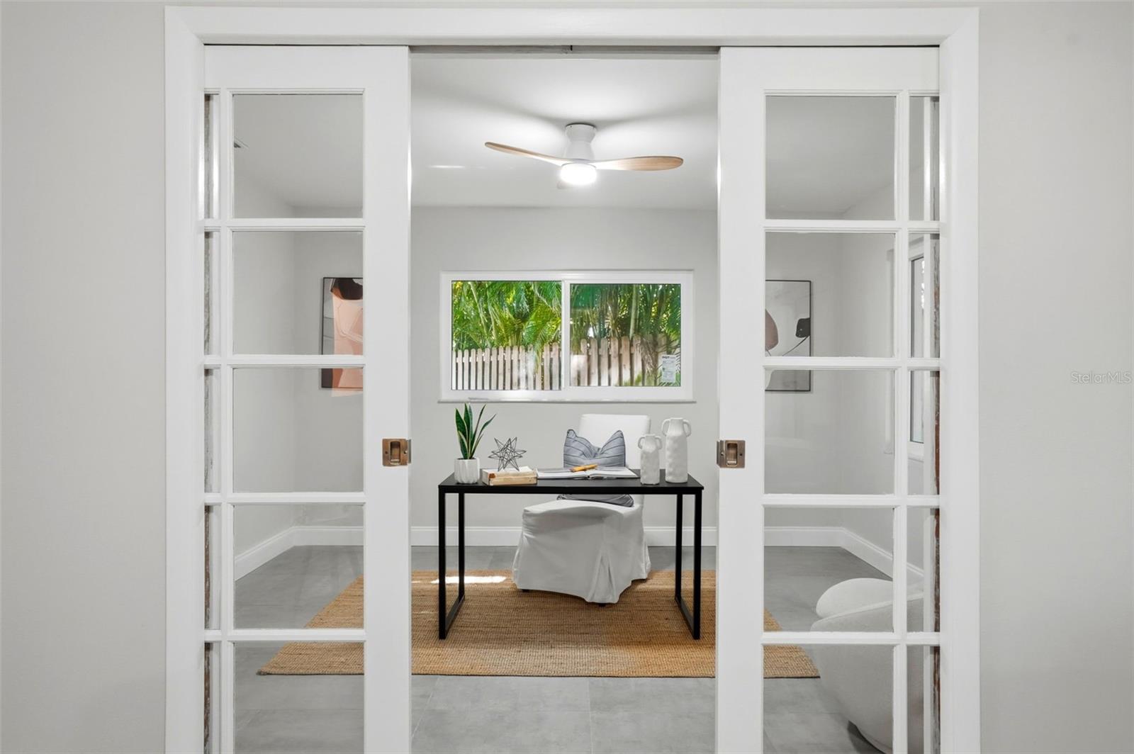 French pocket doors open to an additional room creating an ideal spot for a home office, studio, yoga room, or quiet retreat.
