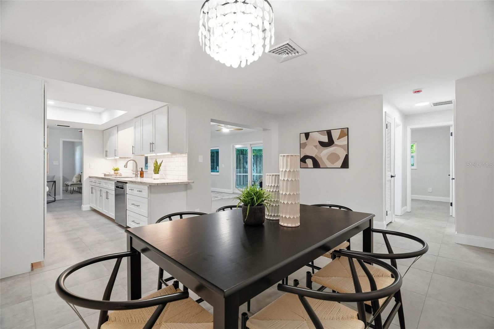 Casual and formal dining options, along with a separate living room and family room, provide flexibility for gathering and entertaining.