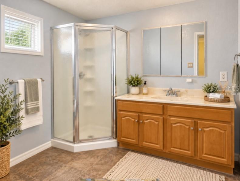 Virtually staged  en suite bathroom. There is no towel bar to the left side.
