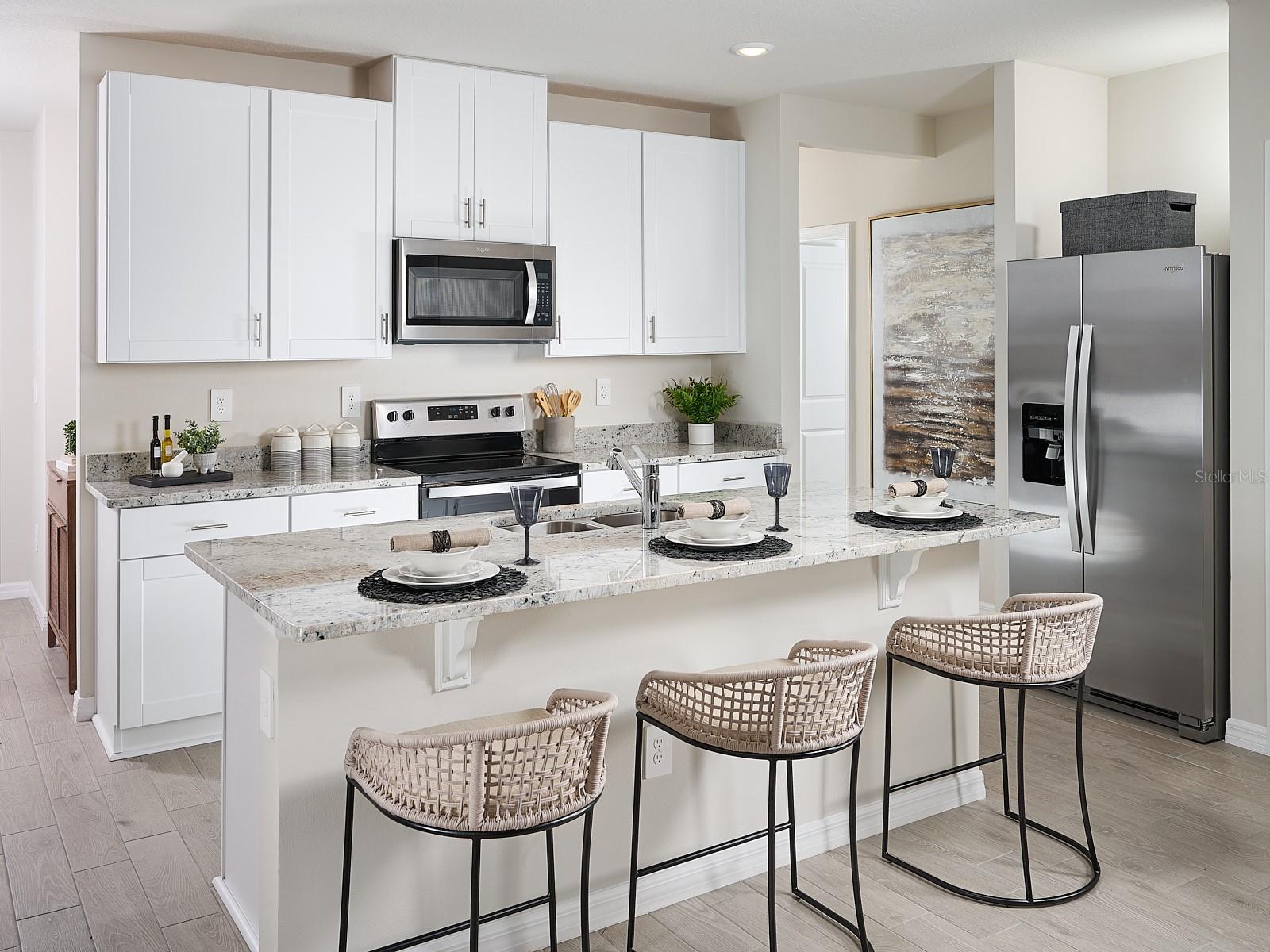 Can you make this description for Coasterra for MLS with a warm but sales appeal: This versatile floorplan offers four bedrooms, two full baths and family room, complemented by an open-concept kitchen, dining area, and great room designed for gathering and entertaining.