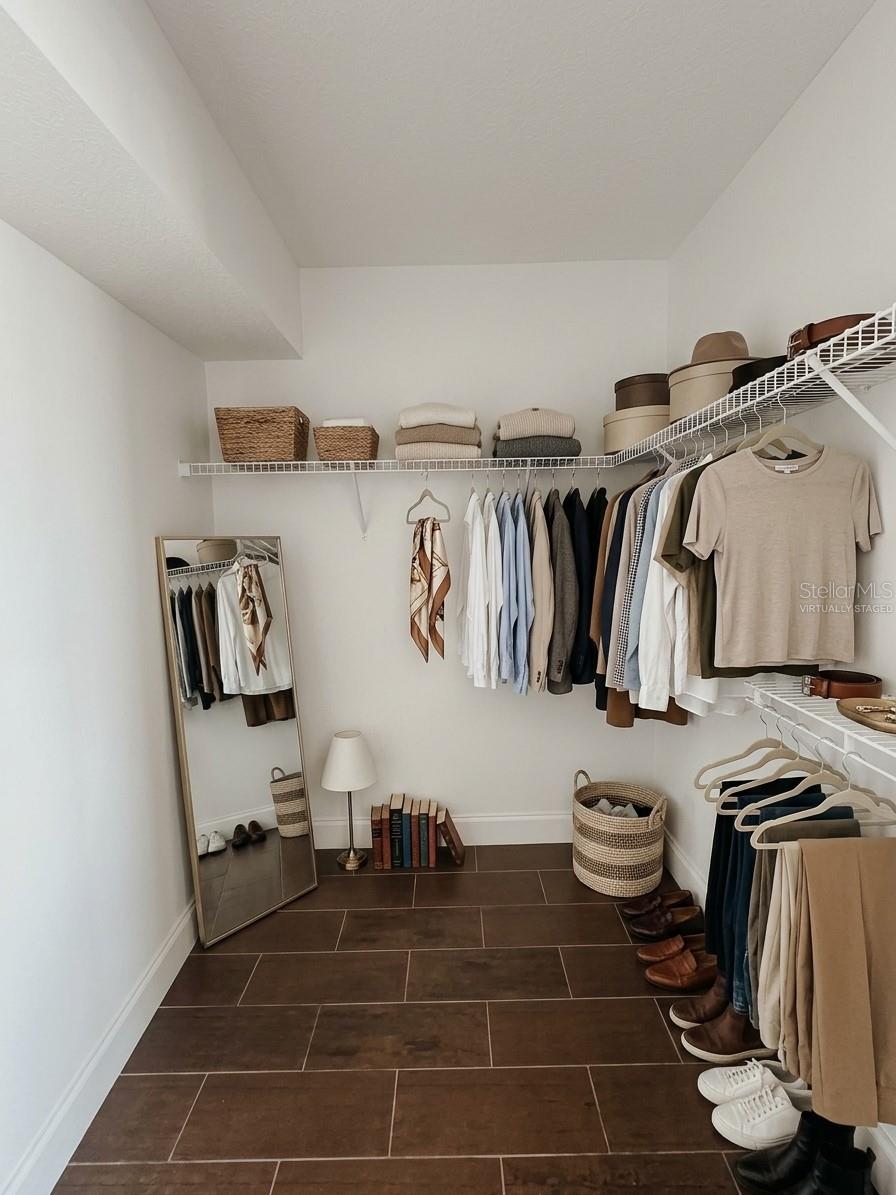 Virtually Staged Primary Bedroom Walk In Closet