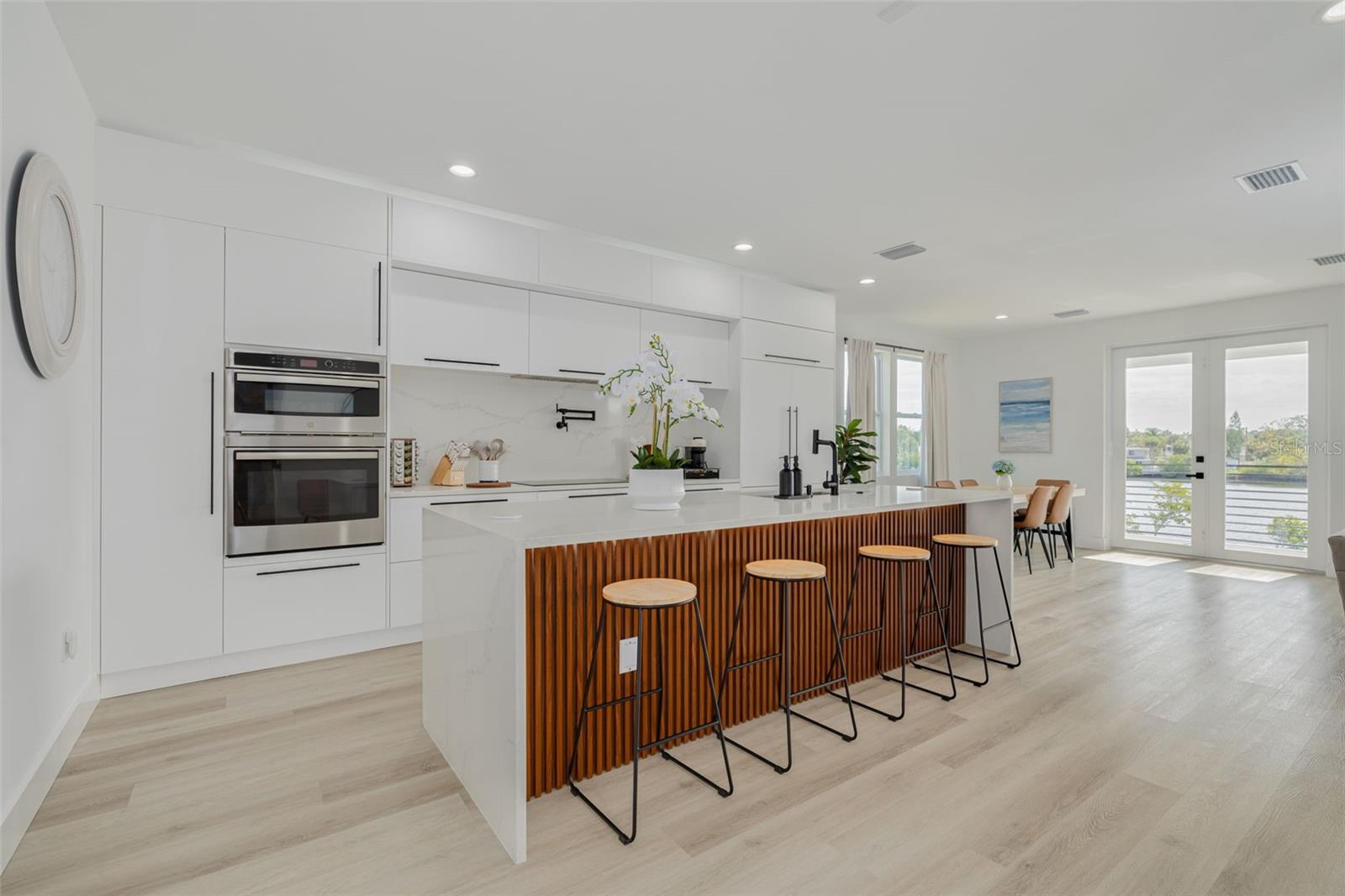 Kitchen, dining and living area on main level with beautiful water views. Kitchen, dining and living area on main level with beautiful water views.