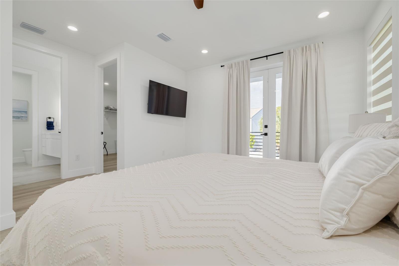 Bedroom with balcony and an ensuite on the main living floor.