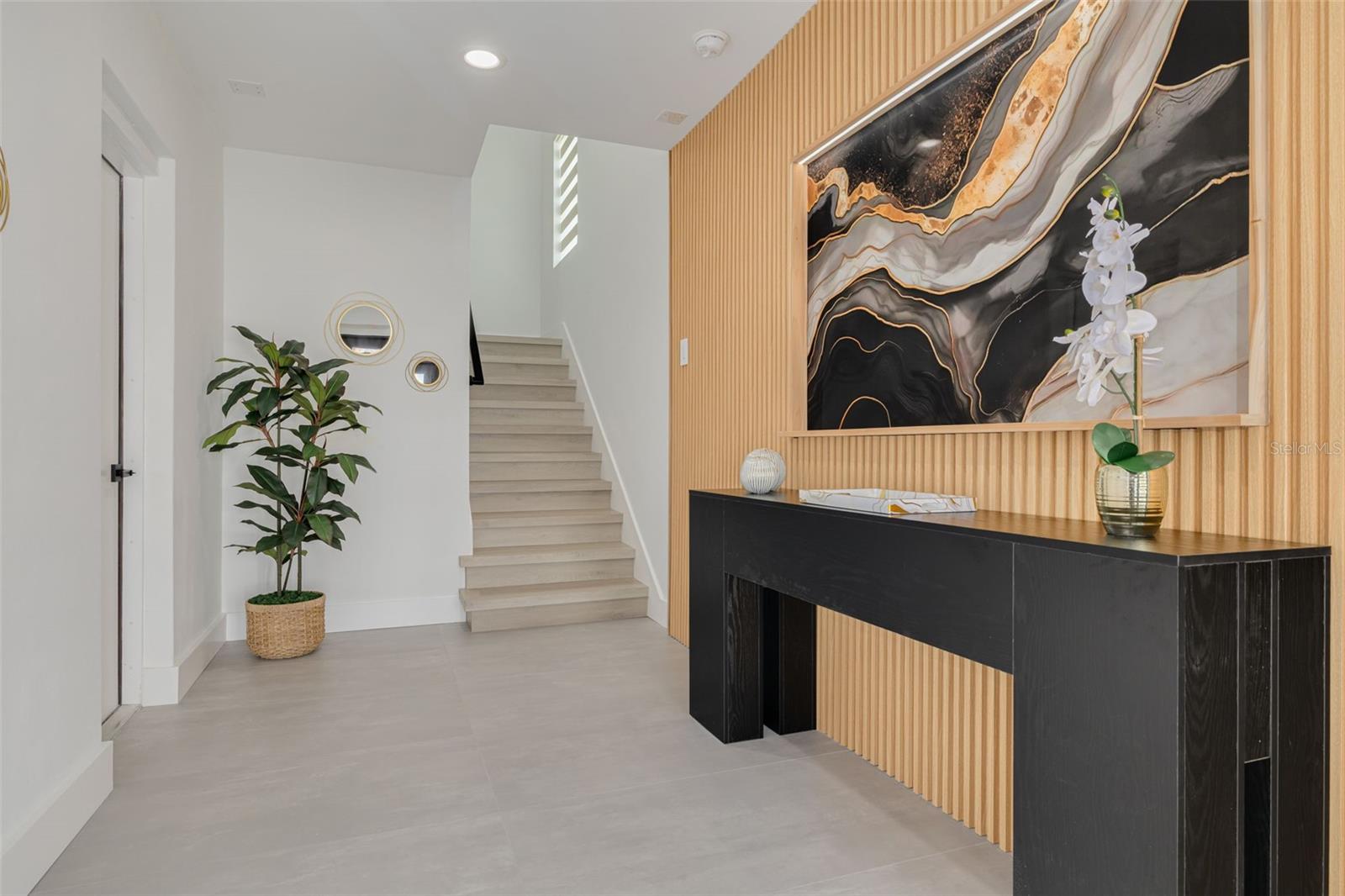 Entry way on the ground floor with the garage entrance on the door to the left. Entry way on the ground floor with the garage entrance on the door to the left.