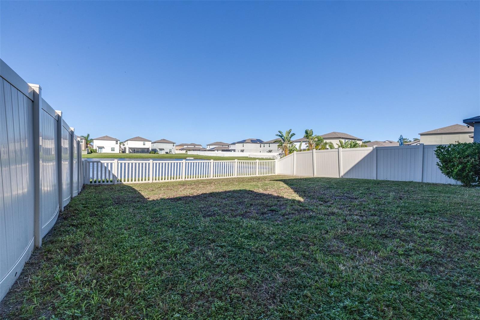 Fully Fenced yard overlooking pond