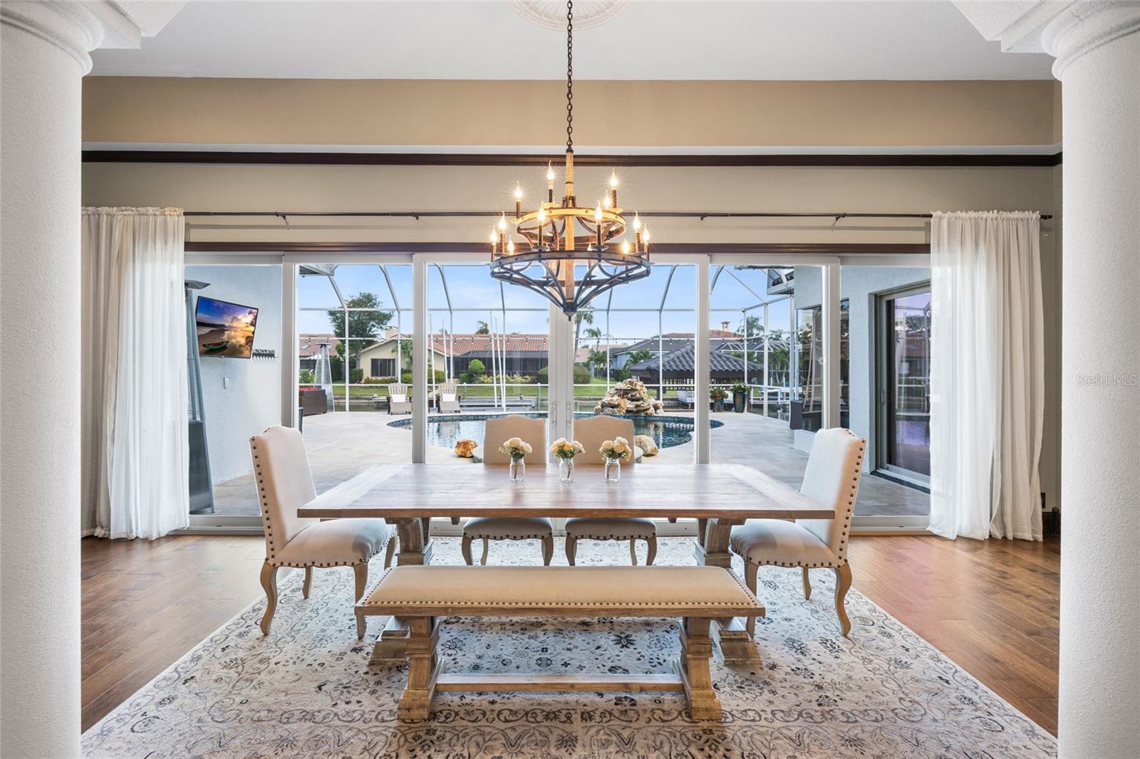 Formal dining with sliders out to pool area