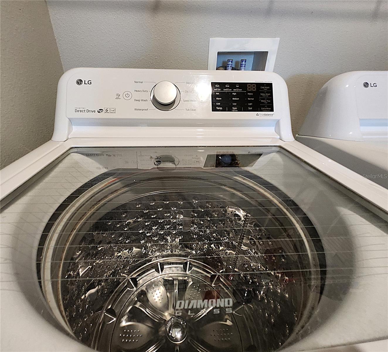 Interior Laundry Room includes side-by-side washer and dryer, ventilated shelves, and storage space