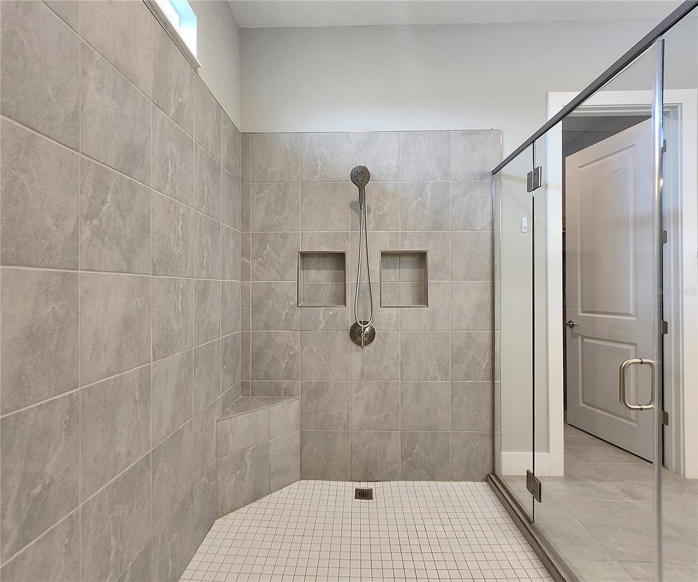 Master bathroom includes large walk-in  tiled shower, water closet, walk-in closet, dual sink vanity, granite countertops