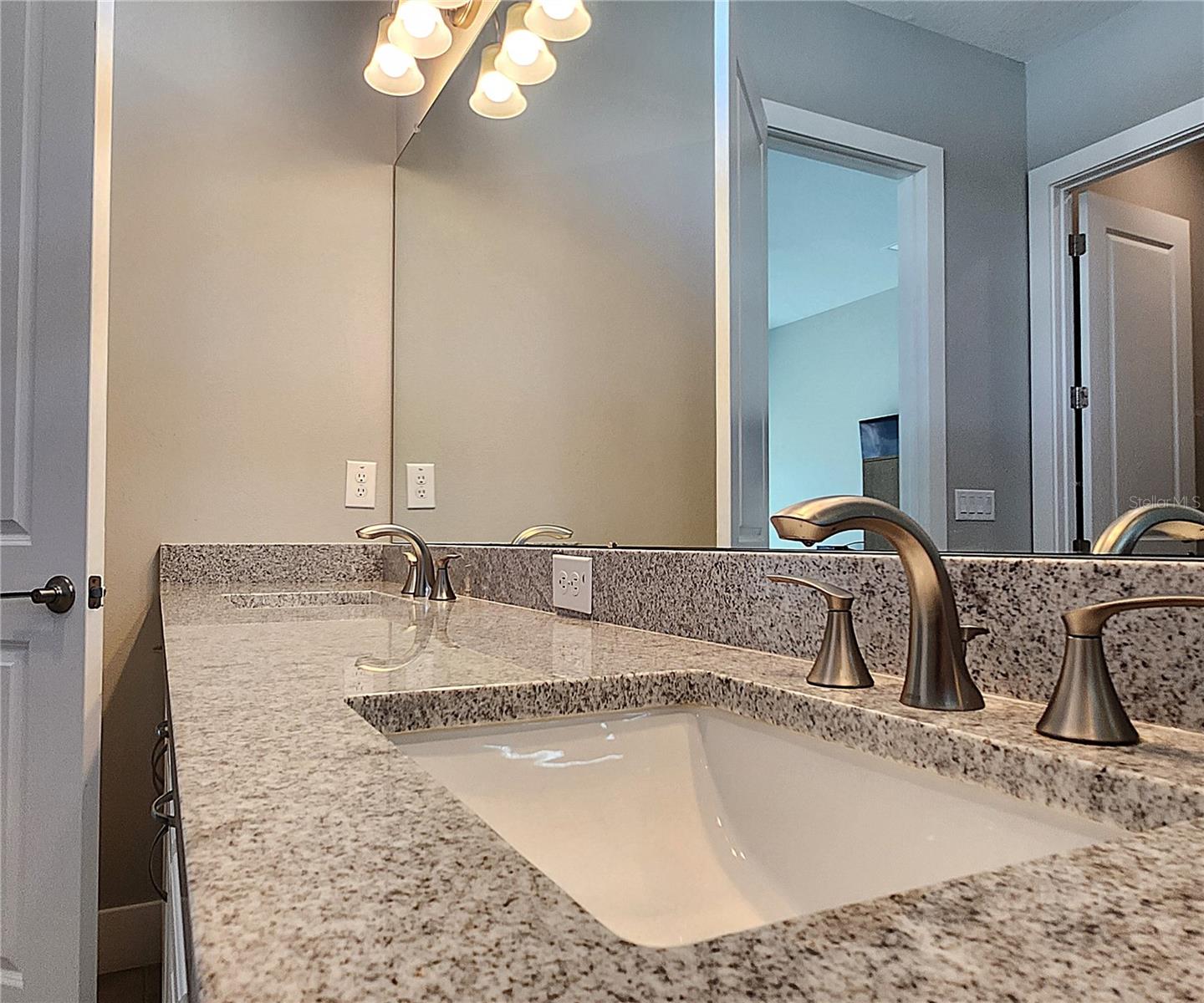 Master bathroom includes large walk-in  tiled shower, water closet, walk-in closet, dual sink vanity, granite countertops