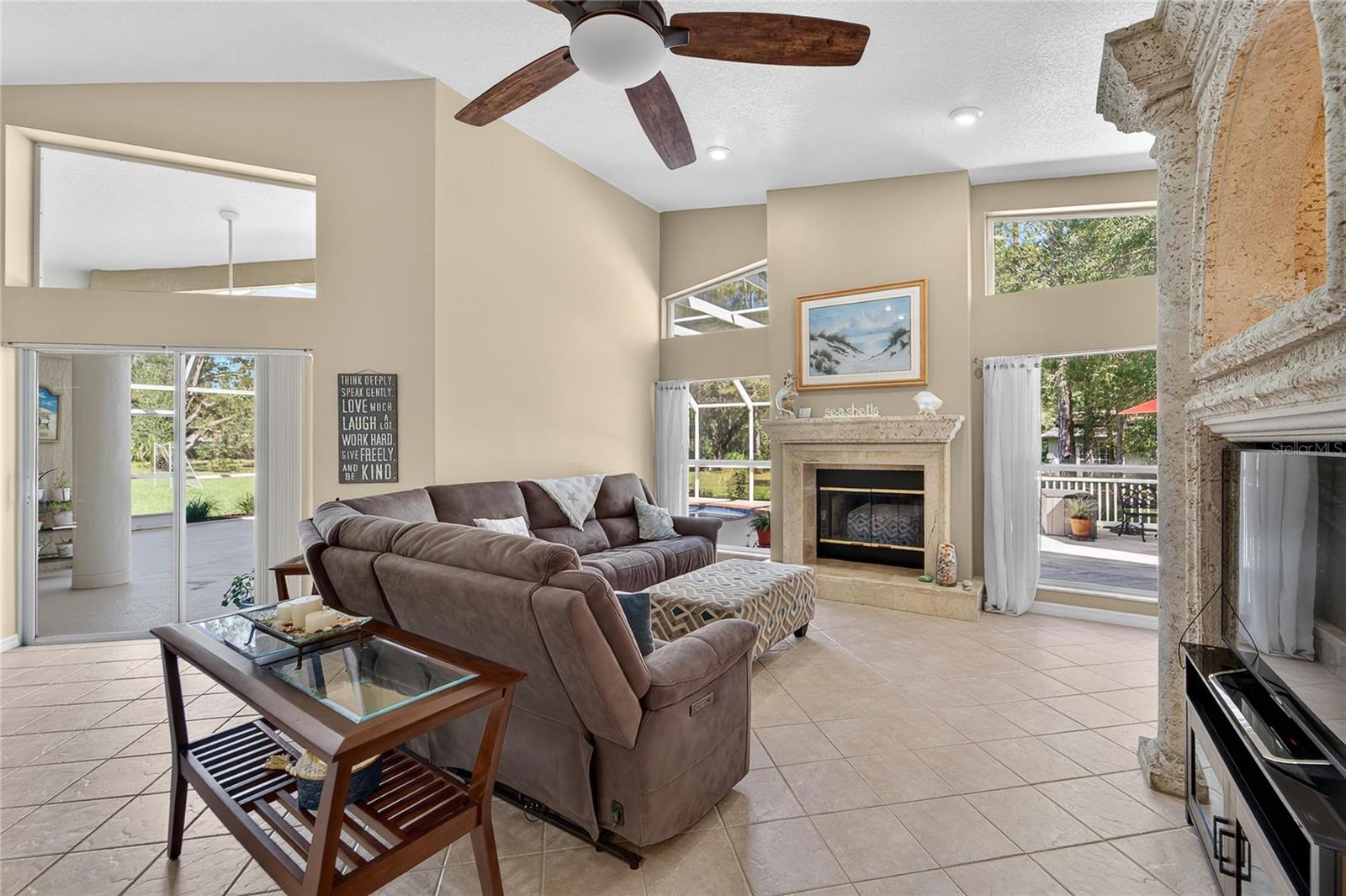Family room is open to the kitchen, overlooks the pool and has a wood burning fireplace