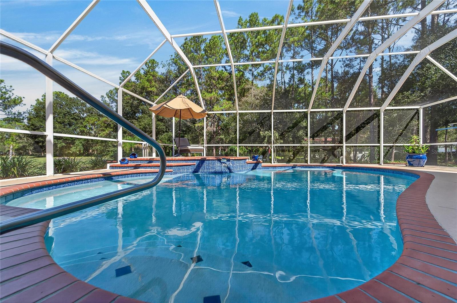 Large family pool has a cascading spa