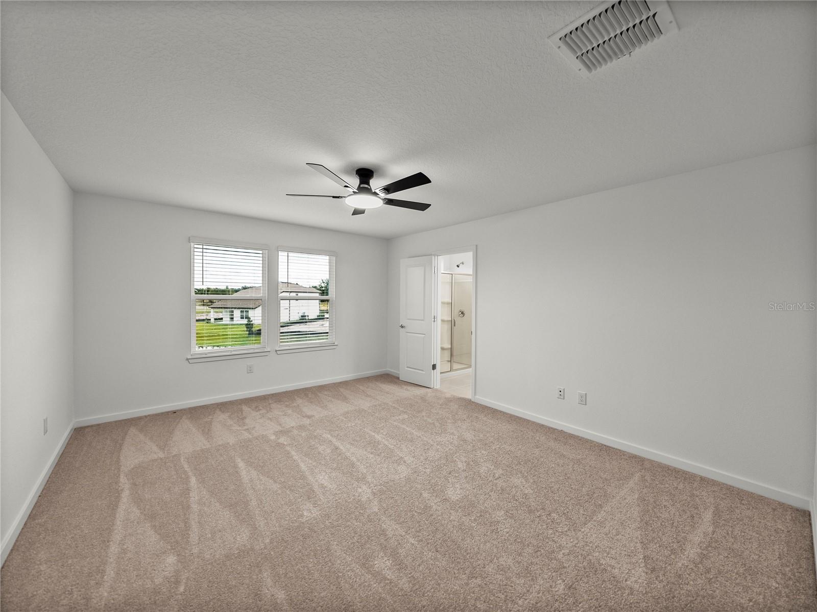 Primary Suite with New LED Ceiling Fan and Views to the Pond