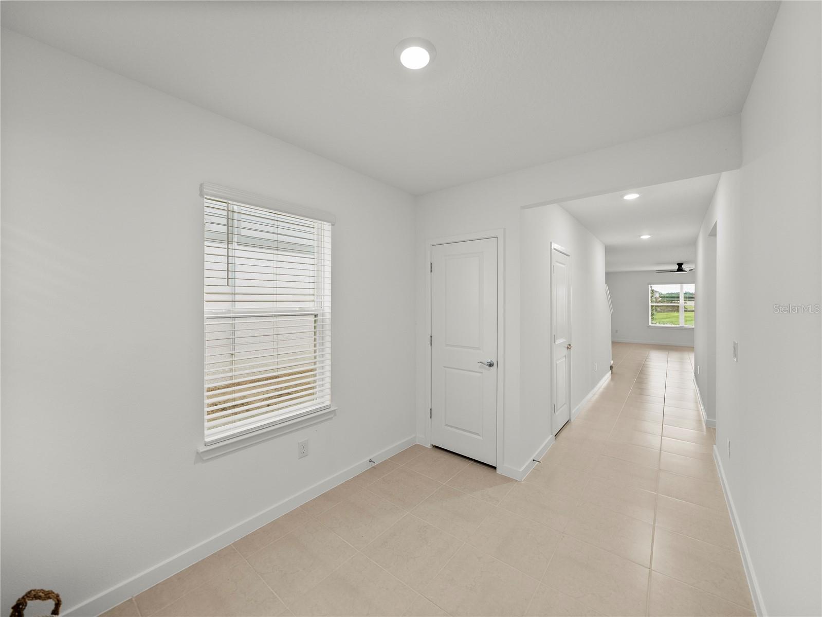 Foyer Mud Area with Coat Closet and Under Staircase Storage
