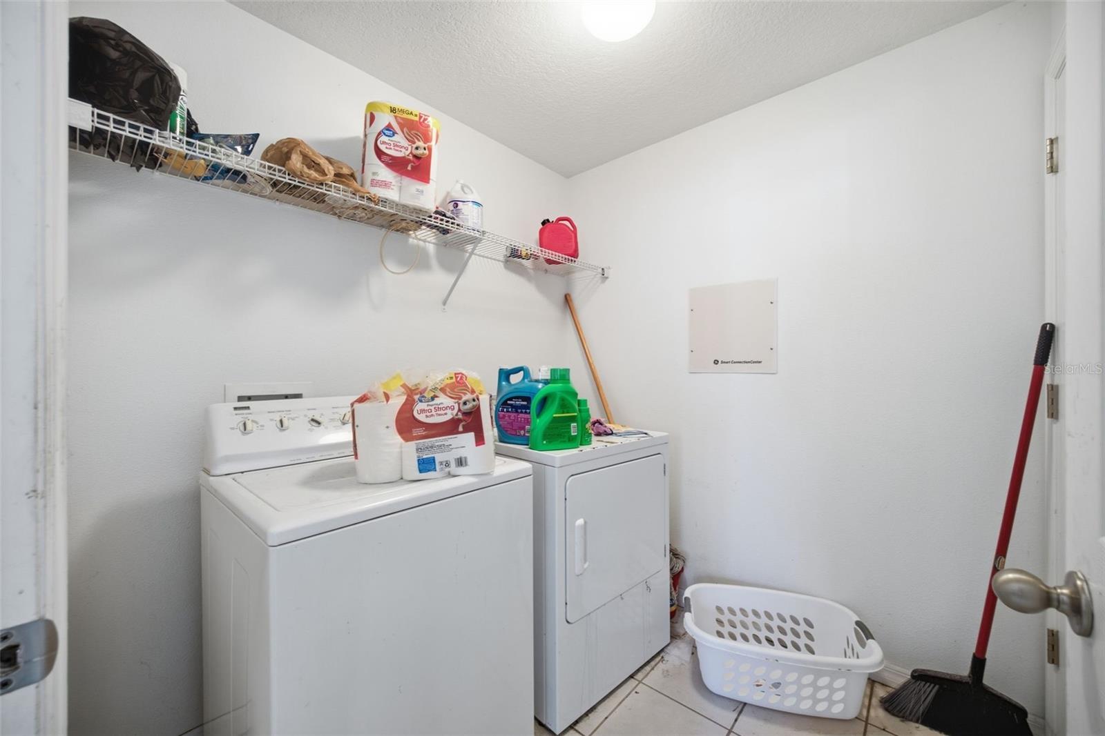 Indoor laundry room 7'0" x 6'7" with washer, dryer and wire shelving