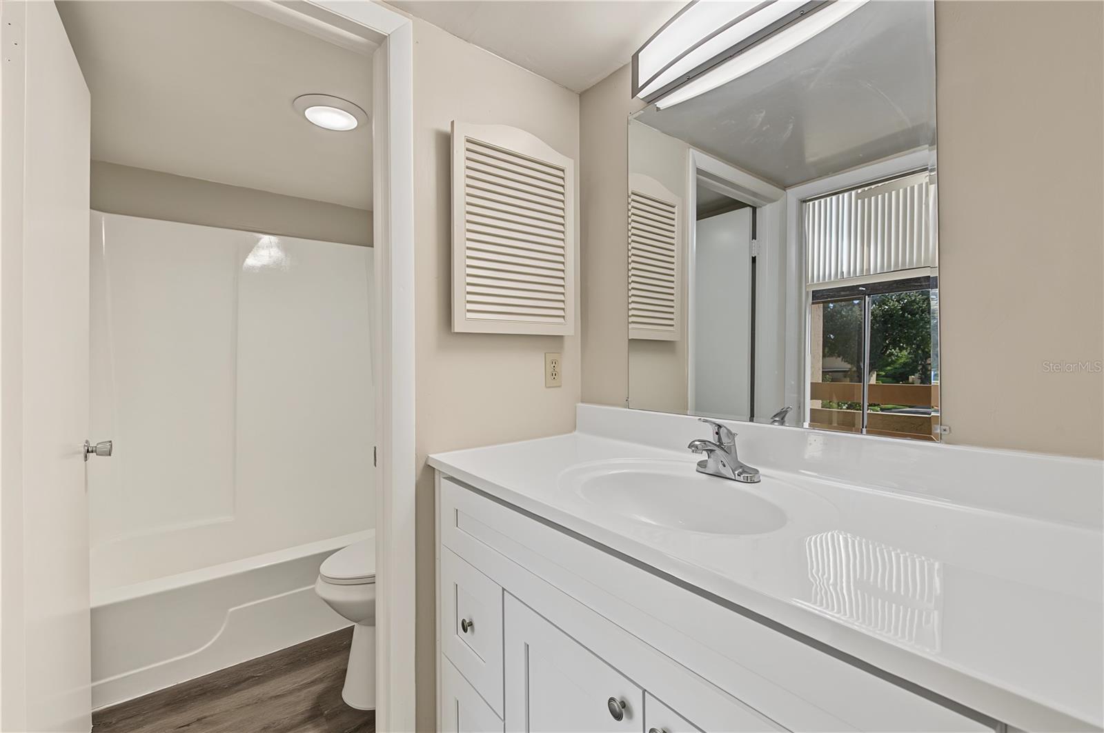Bathroom, new light fixture and laminate flooring.