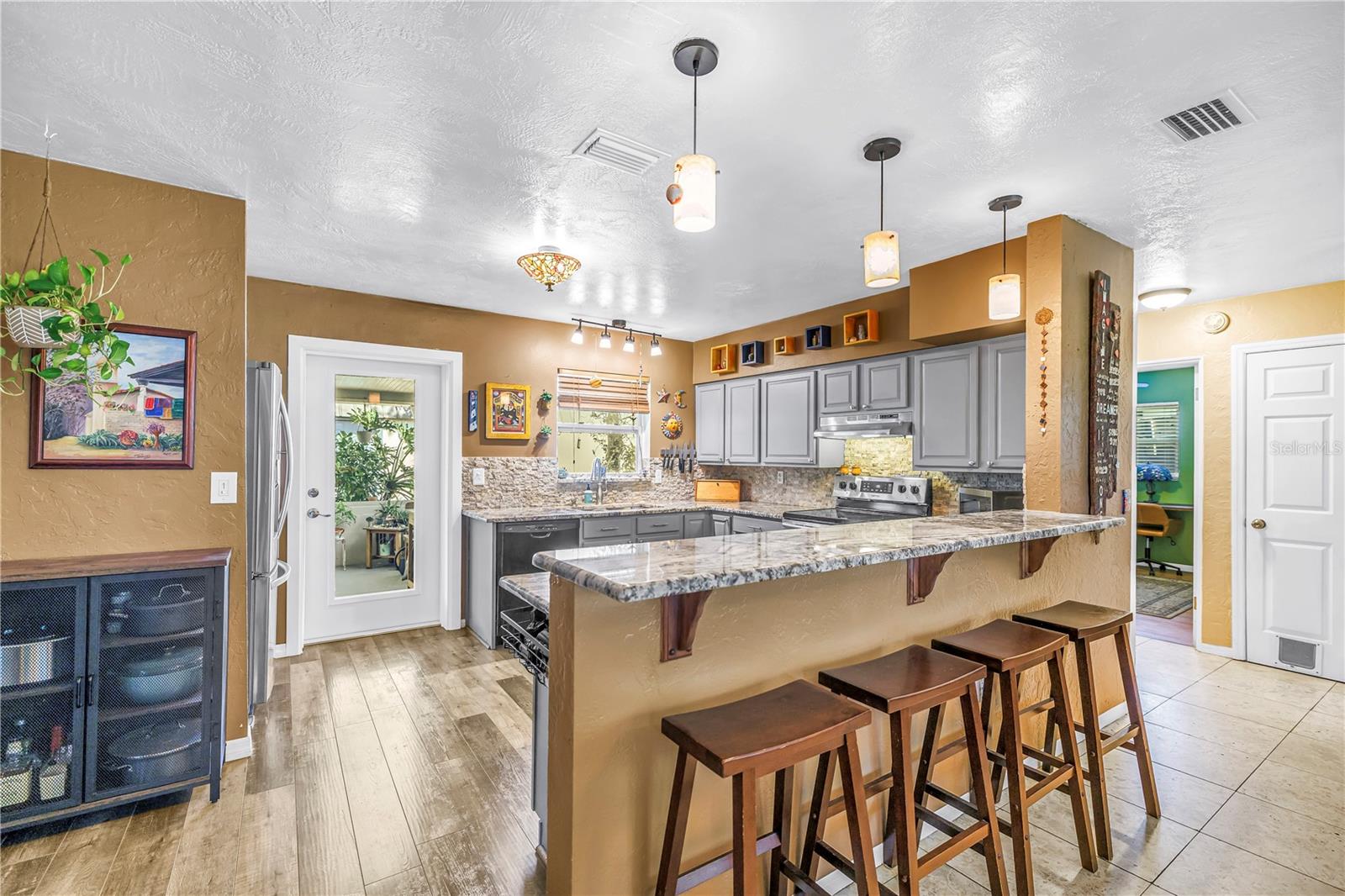 Updated kitchen with granite countertops, dimmable lighting and a glass panel door to access the back yard.