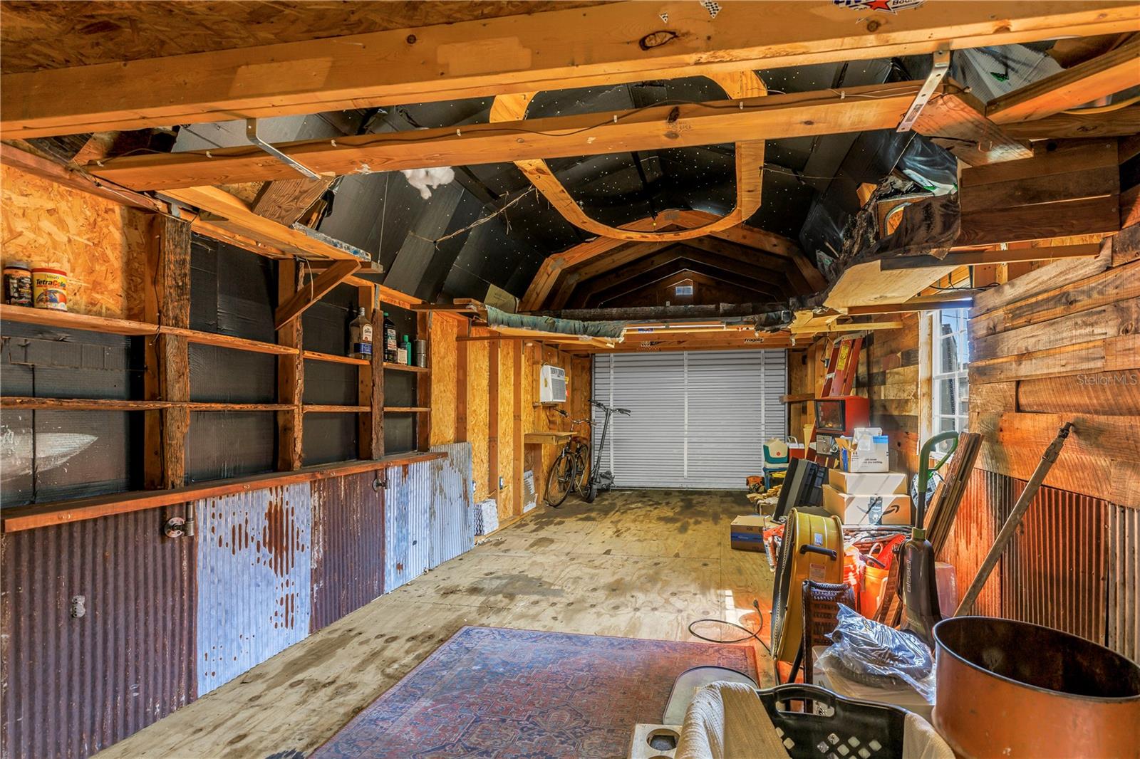Here's a view inside the 31' long workshop featuring the rollup door accessible from the secondary driveway.