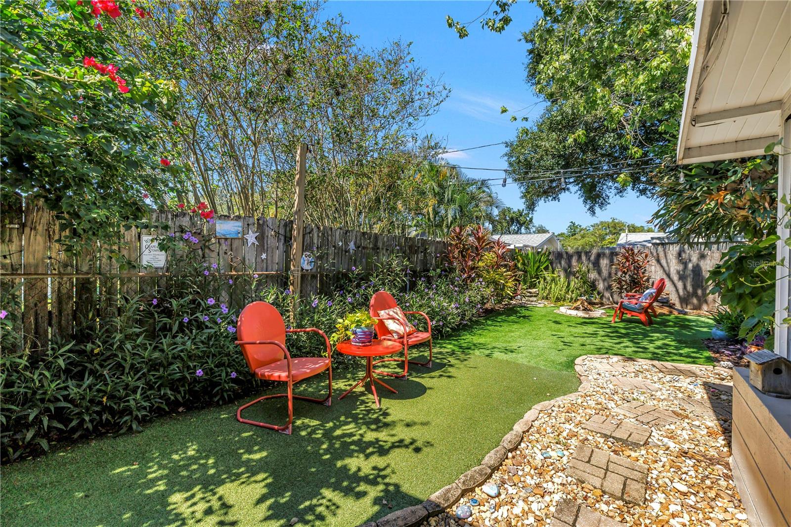 Charming garden pathway leading into the backyard.