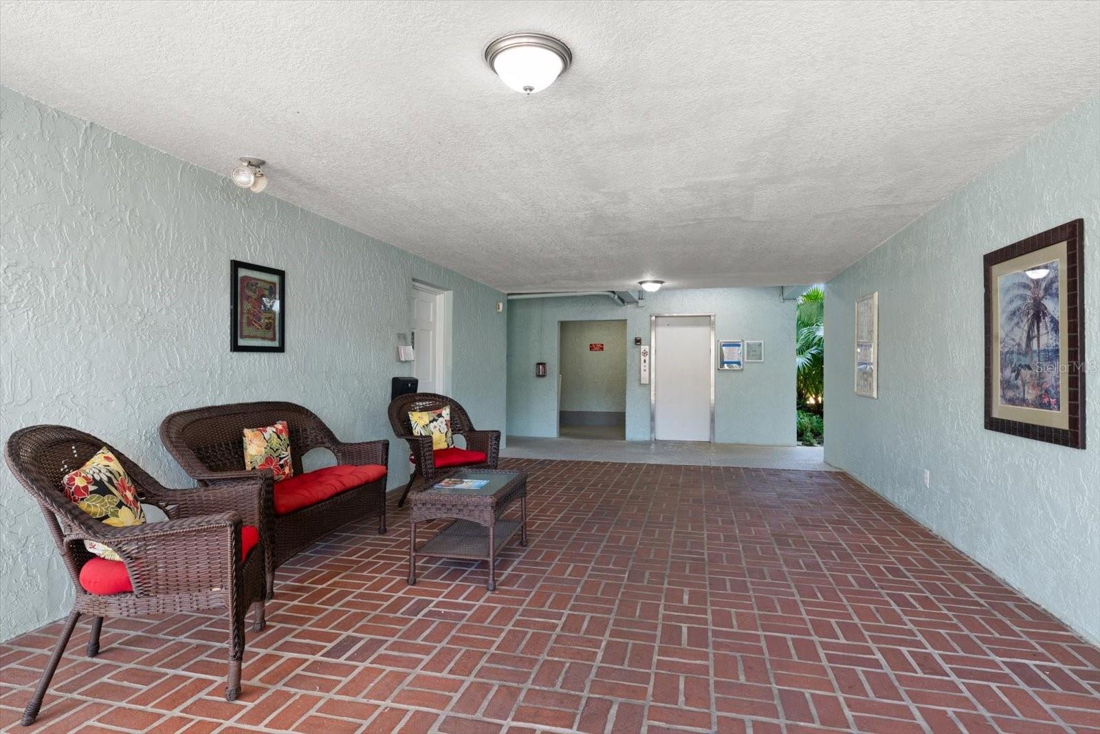 Ground floor building entrance to elevator, bike storage and laundry facility