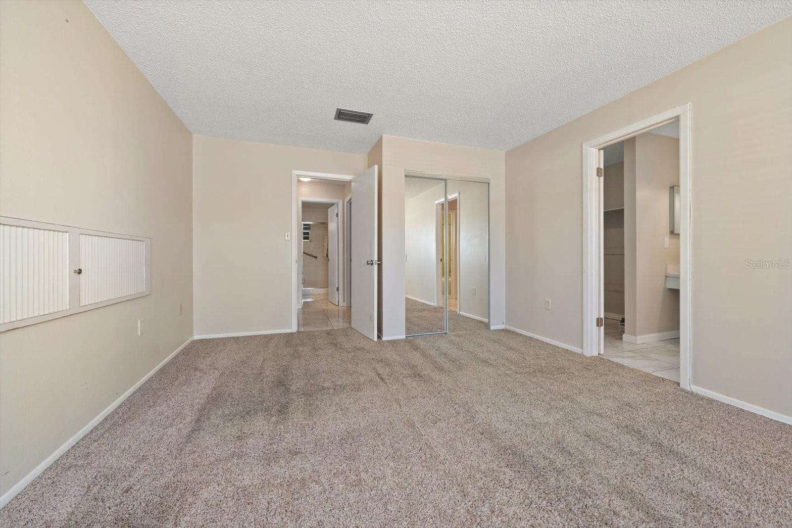 Primary suite with additional closet, en suite bath and walk in closet