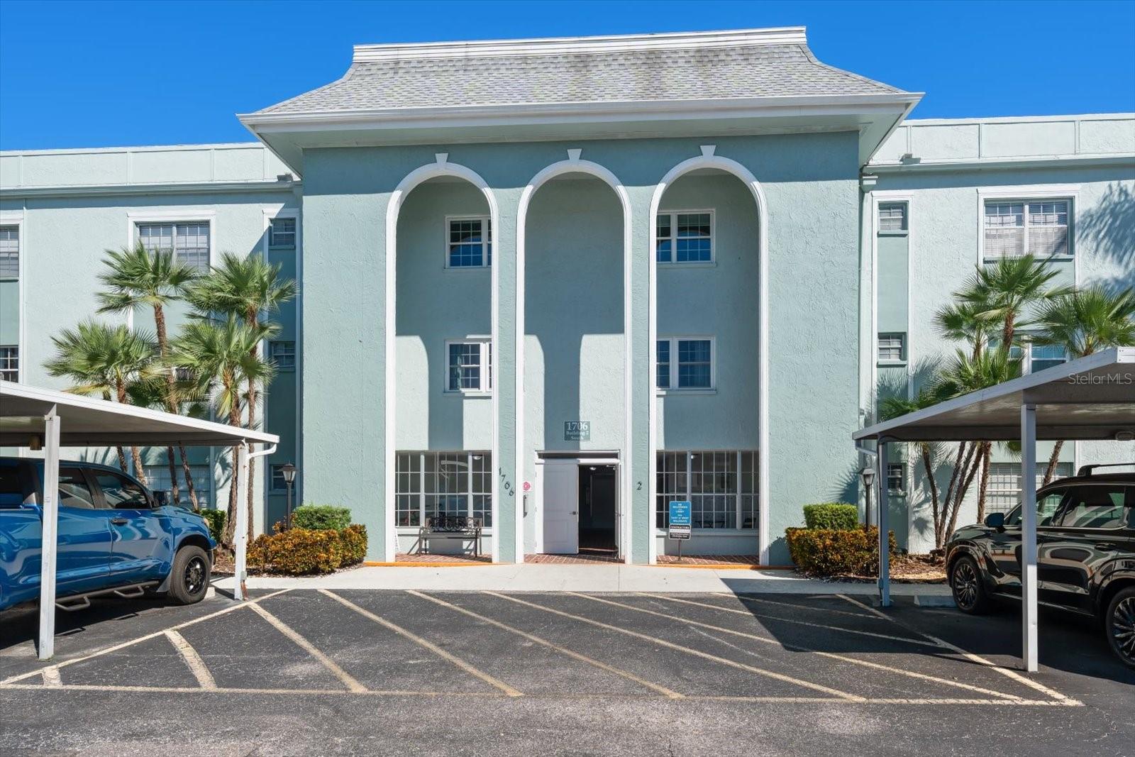 Front of condo building and carports