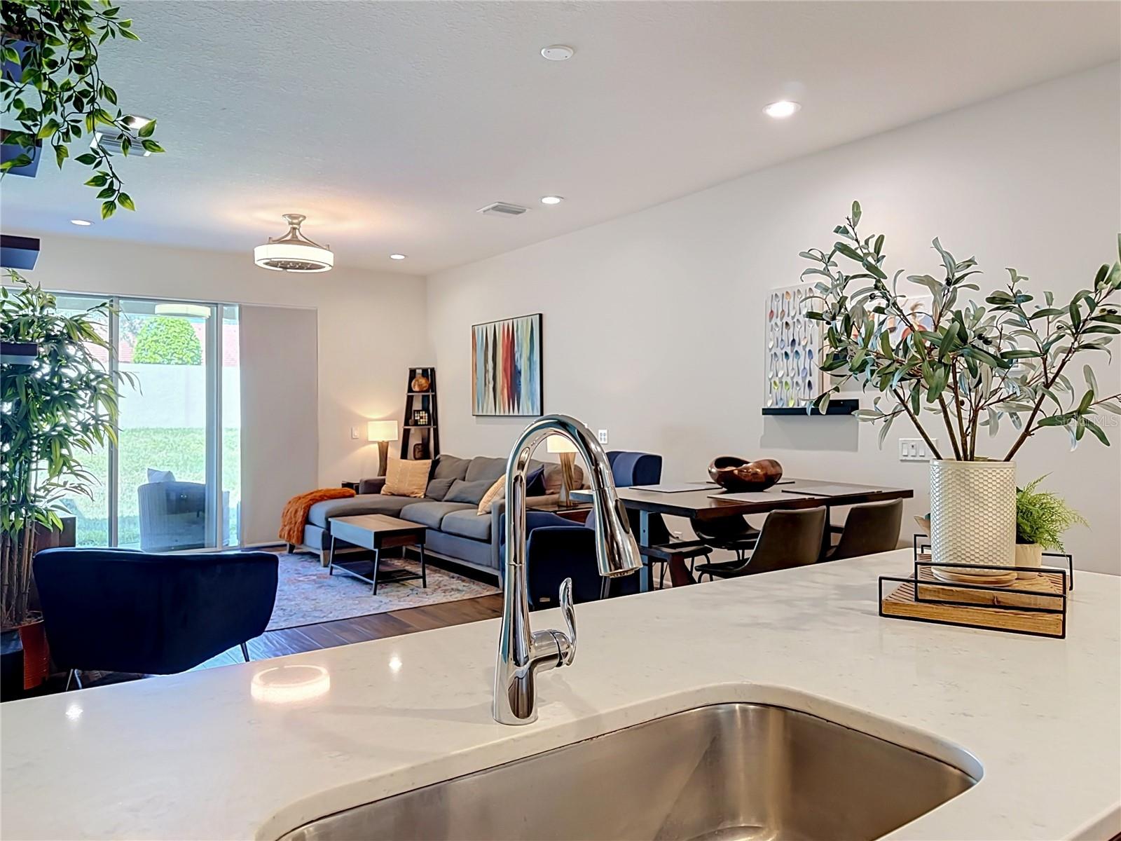 The well-appointed kitchen offers SOLID WOOD CABINETRY, GRANITE countertops, stainless steel appliances, a breakfast bar, and ample storage.